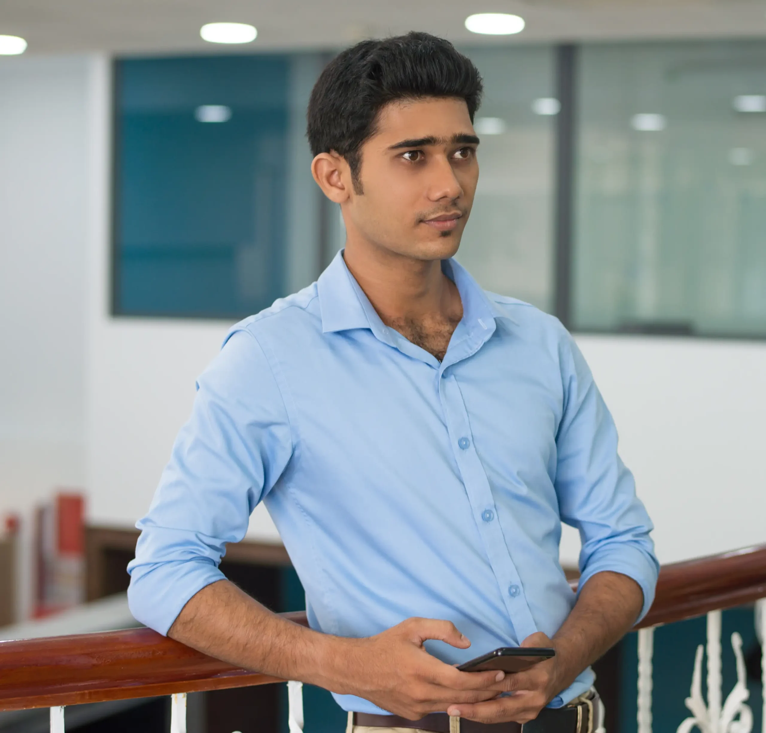 serious-pensive-young-man-with-smartphone-leaning-railing